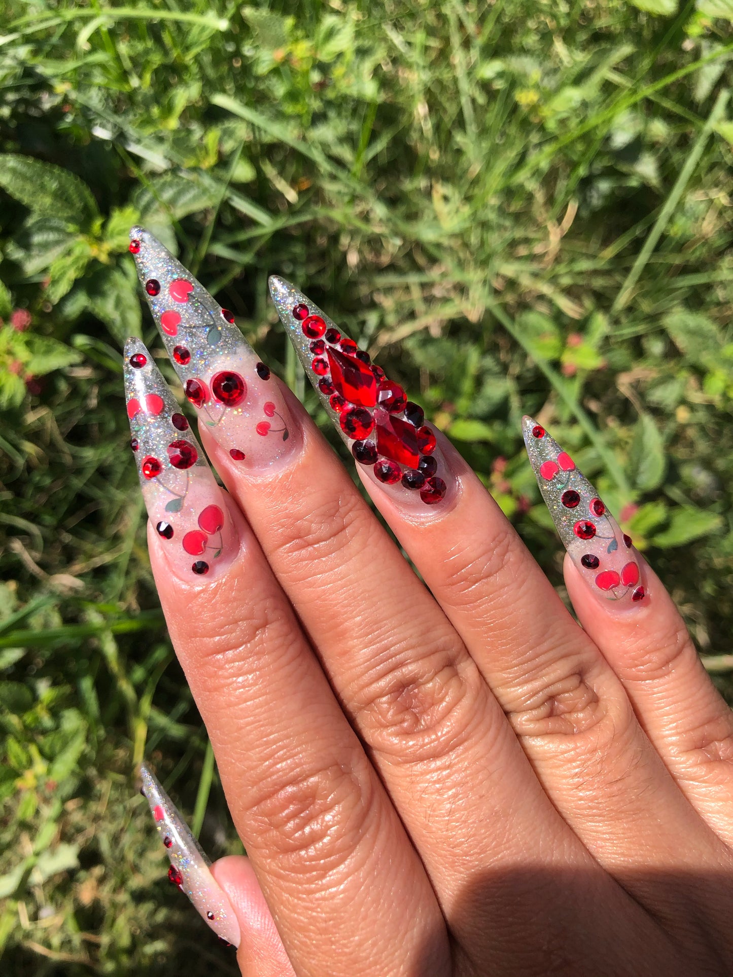 cherry nail art with glitter and gems on stiletto nails