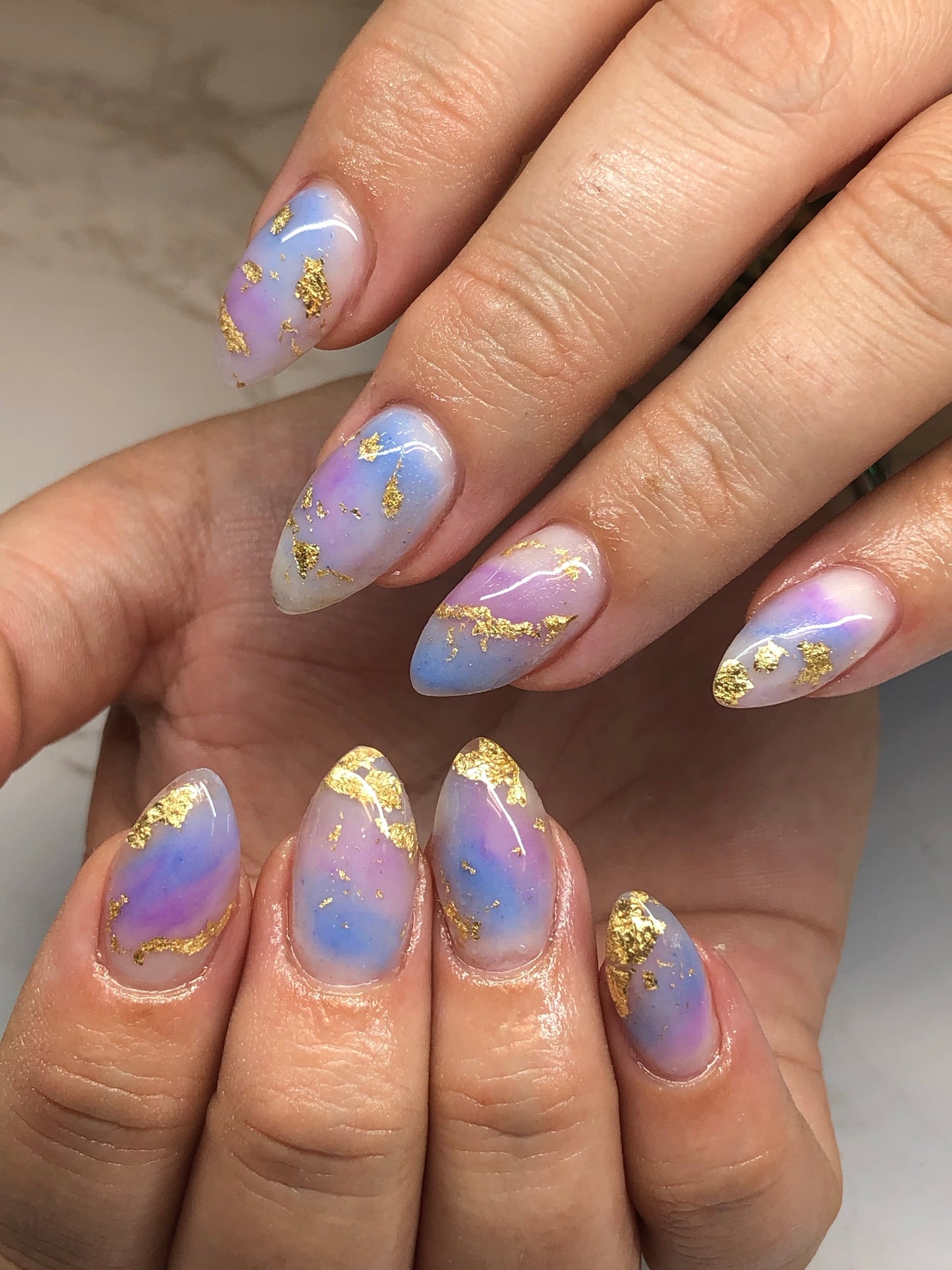 short almond nails with gold foil nail art